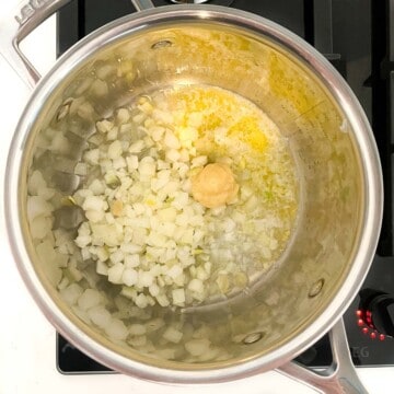 Onions, garlic and butter frying in a saucepan.