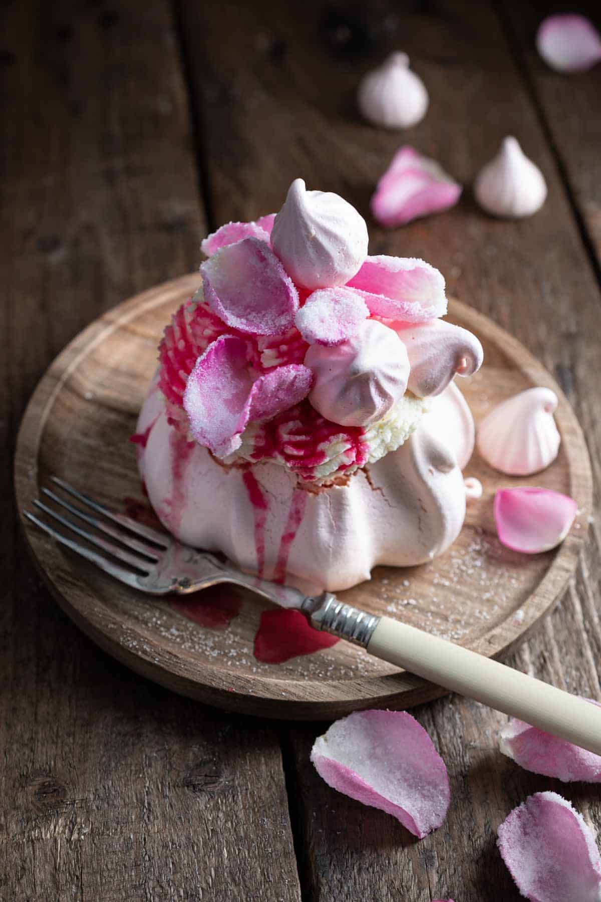 One mini rose pavlova served on a plate 