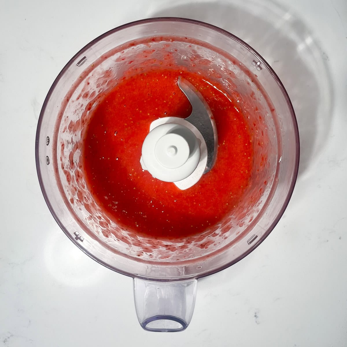 Pureed strawberries in a blender.