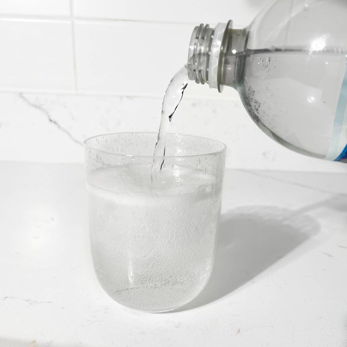 Pouring lemonade into glass.