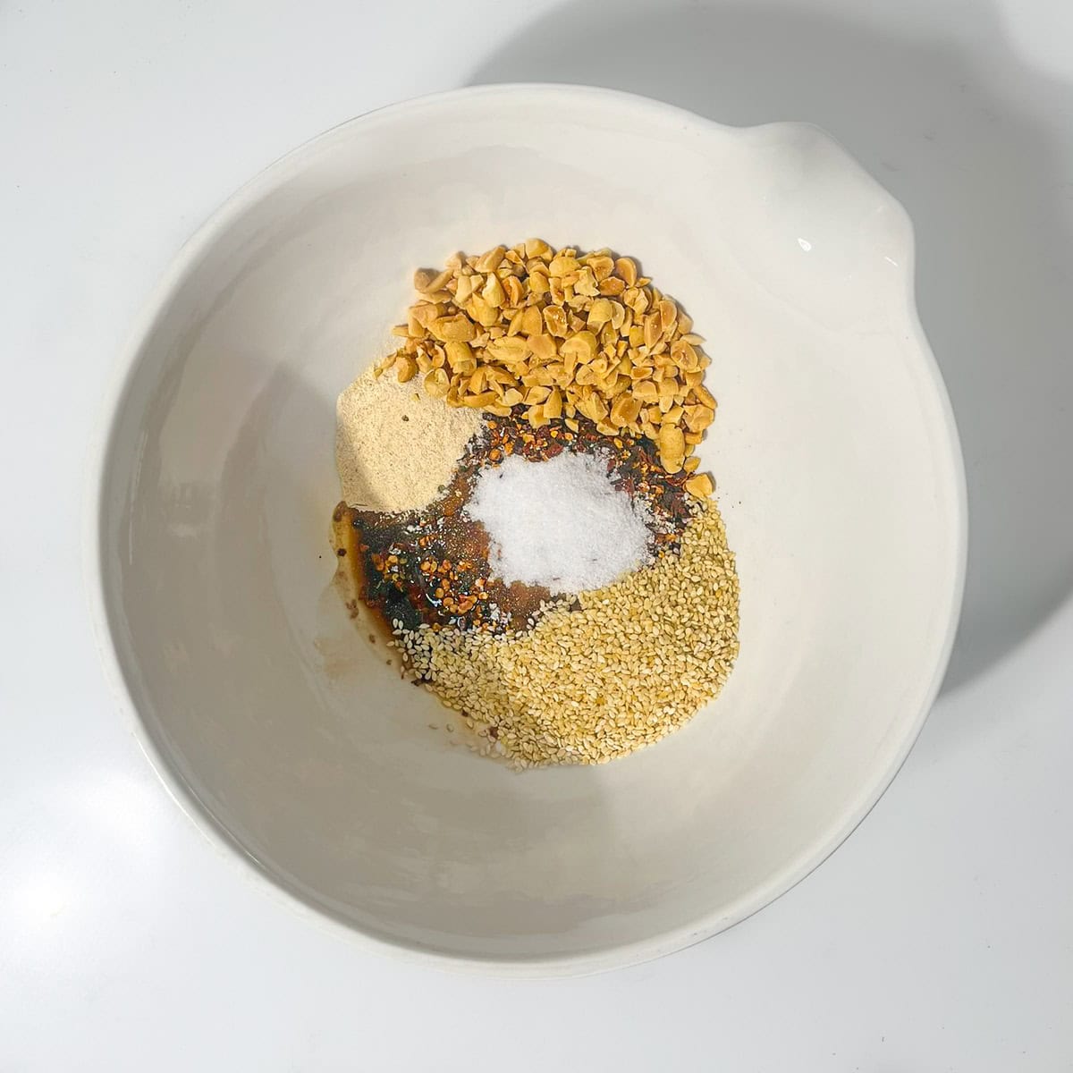 Crispy chilli oil dry ingredients in a large white bowl.