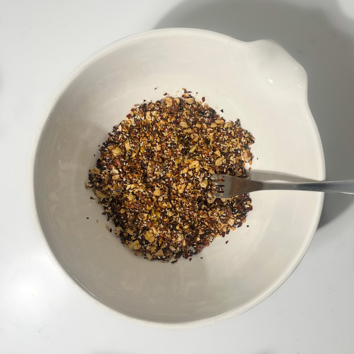 Crispy chilli oil dry ingredients mixed in a large white bowl.