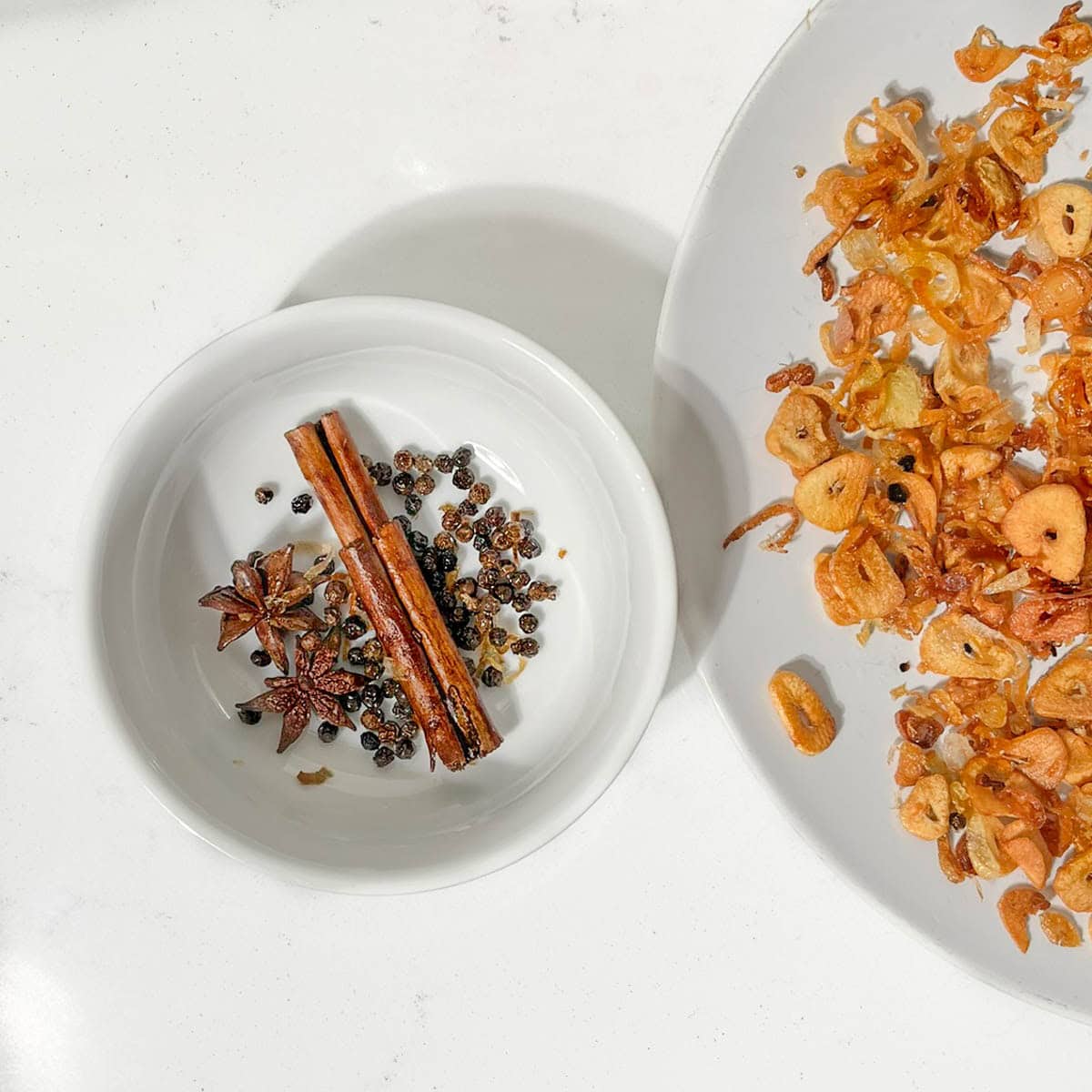 Picking out the large spices and peppercorns from the chilli crisp oil micture.