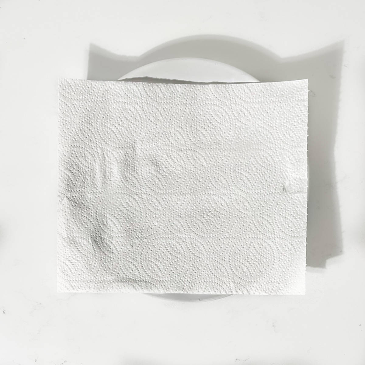 A plate covered with kitchen paper.