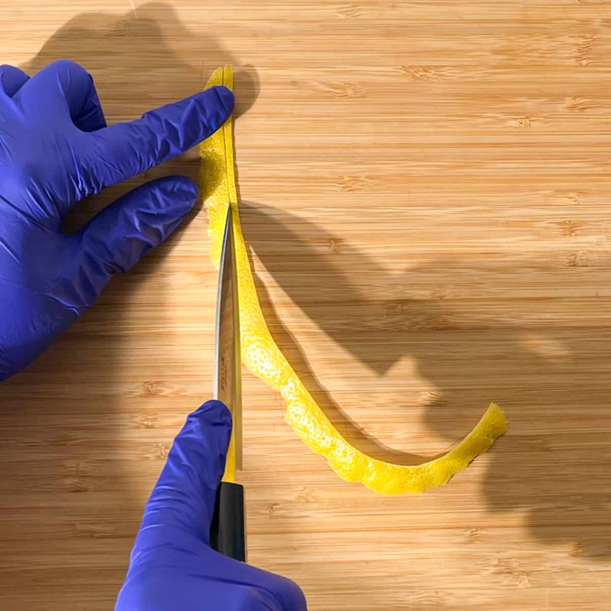 Slicing a long strip of lemon peel for the lemon peel twisty to go on the rock shandy glass.