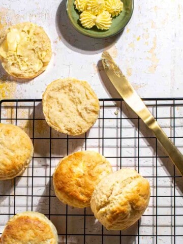 3-Ingredient scones on a black wire rack, served with some butter.