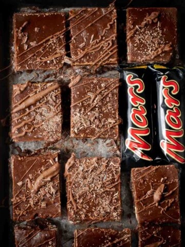 Mars bar slices on a baking sheet with two small Mars bars.
