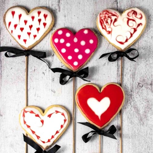 Five valentine's sugar biscuits on sticks.