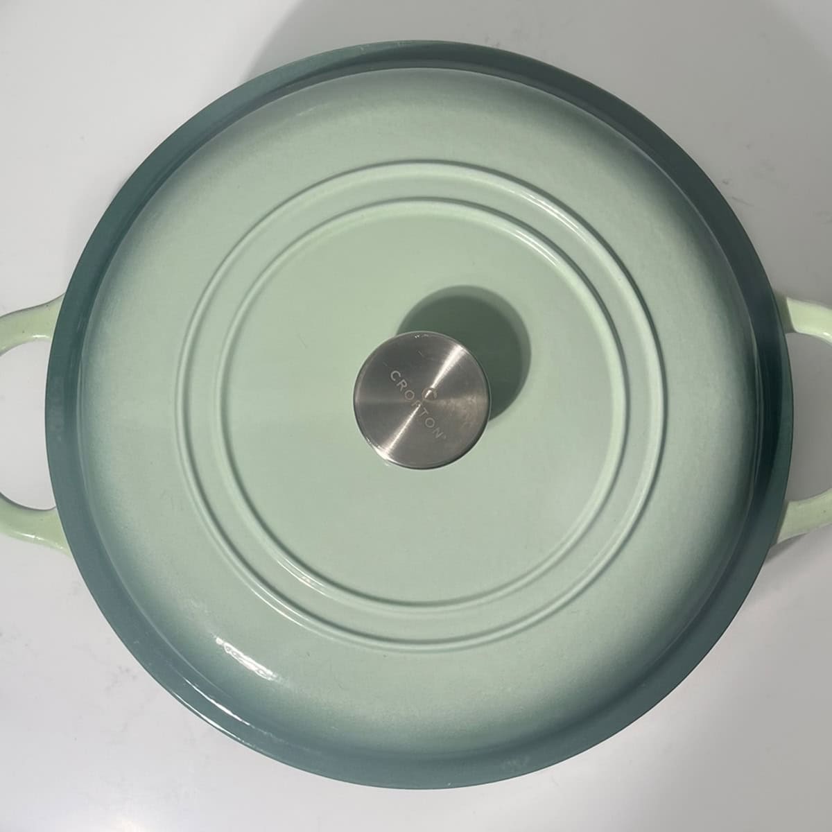 A large green saucepan with a lid on.