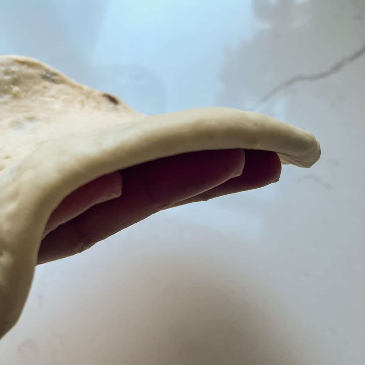 The thickness of the naan.