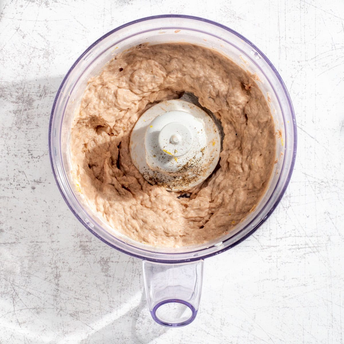Blended tuna pate in the bowl of a food processor.