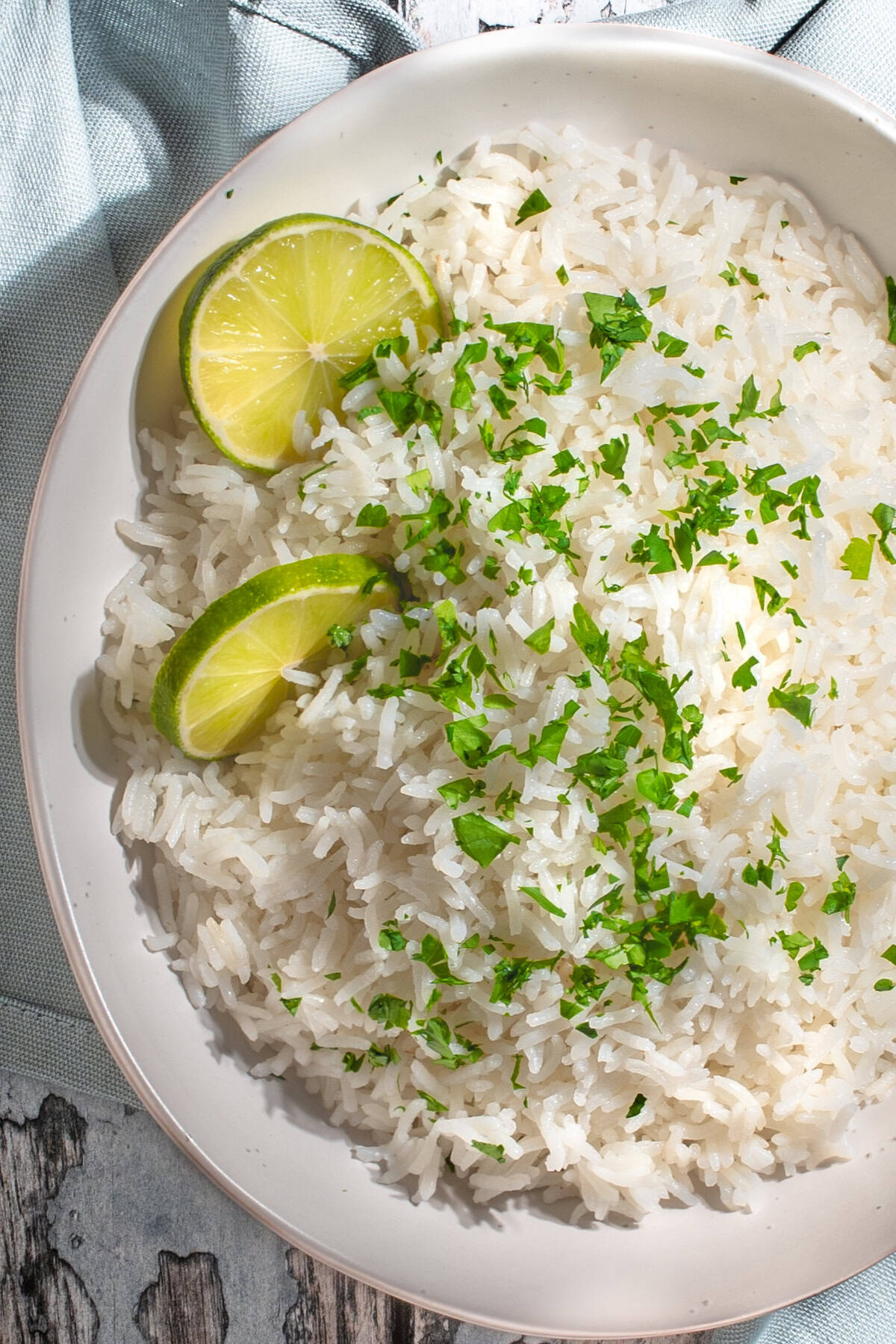 Coconut basmati rice with slices of lime and chopped coriander.
