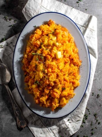 Carrot and swede mash on an oval plate.