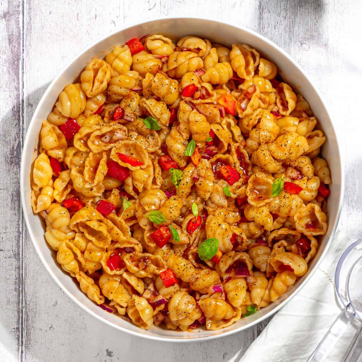 Curry noodle salad in a large white bowl.