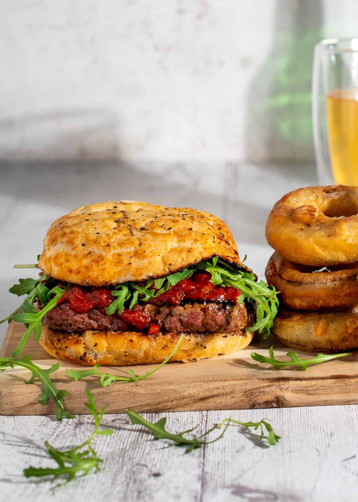 South African-style prego roll with rump steak, tomato chilli sauce, rocket and onion rings.