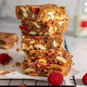 A stack of raspberry and white chocolate blondies.