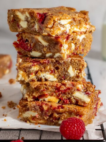 A stack of raspberry and white chocolate blondies.