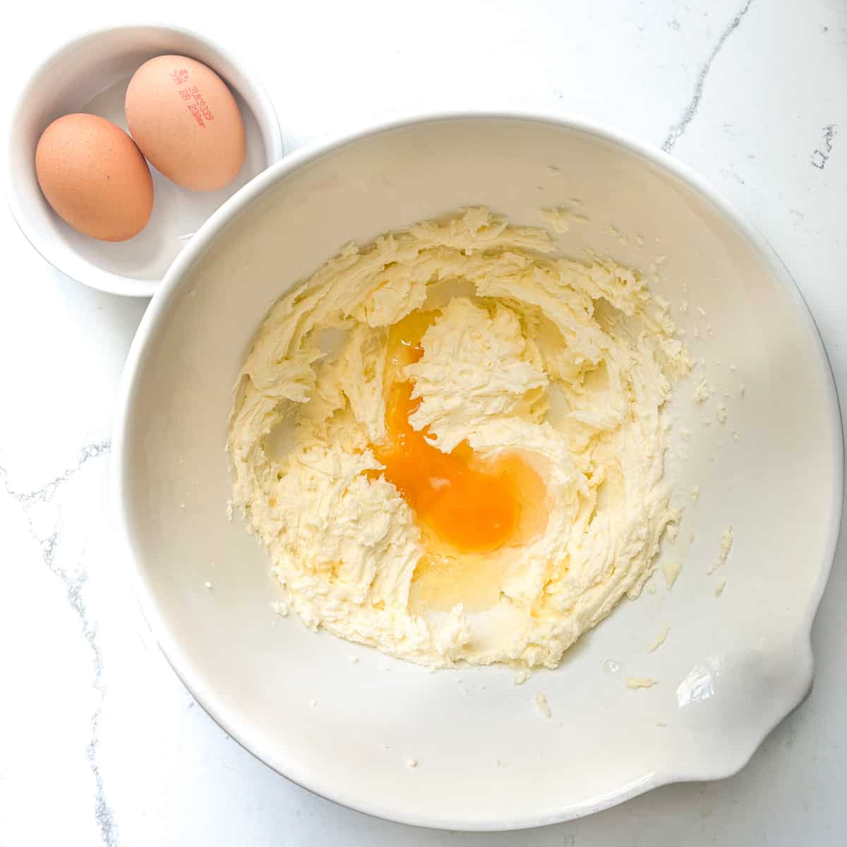 Egg added to sugar and butter in a large mixing bowl.