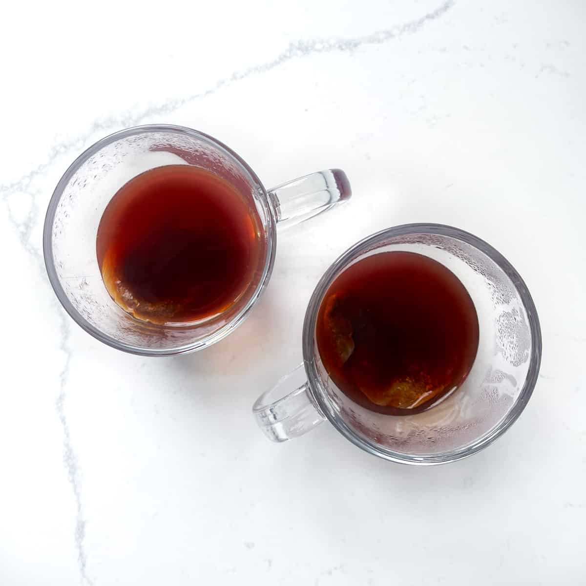 Strong Rooibos tea in two glass mugs.