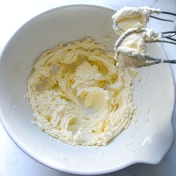 Butter and sugar beaten to a light colour and a creamy texture in a mixing bowl.