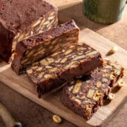 Sliced tinginys, a Lithuanian no-bake biscuit cake with cocoa, condensed milk, peanuts and chocolate chips.