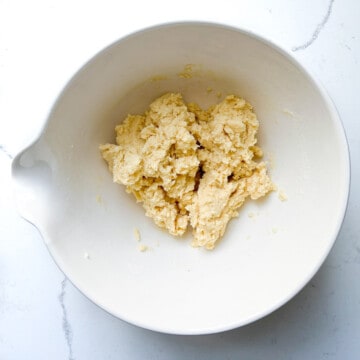 Hallongrotter cookie dough in a large white bowl, ready for rolling.