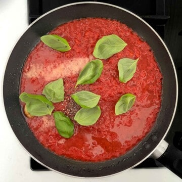 All the ingredients for the tomato sauce added to a frying pan.