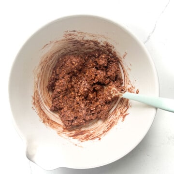 Chokladbollar mixture in a white bowl, ready for rolling.