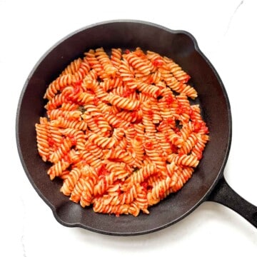 A thin layer of pasta and sauce added to a cast iron pan.