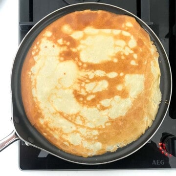 A flipped over pandekager in a pancake frying pan.