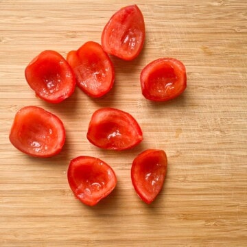 Sliced tomatoes on a chopping board.