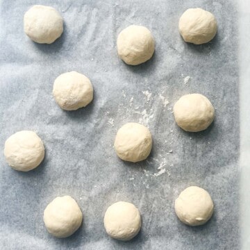 Rondstykker dough balls on a baking tray.