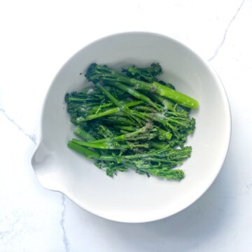 Tenderstem broccoli in a large white bowl.