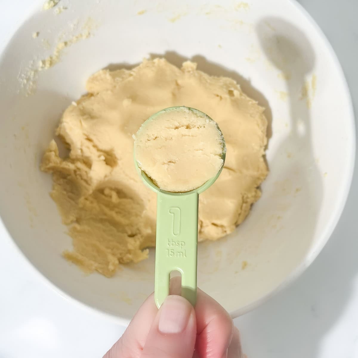 A tablespoon of dough from the thumbprint with icing cookie dough.