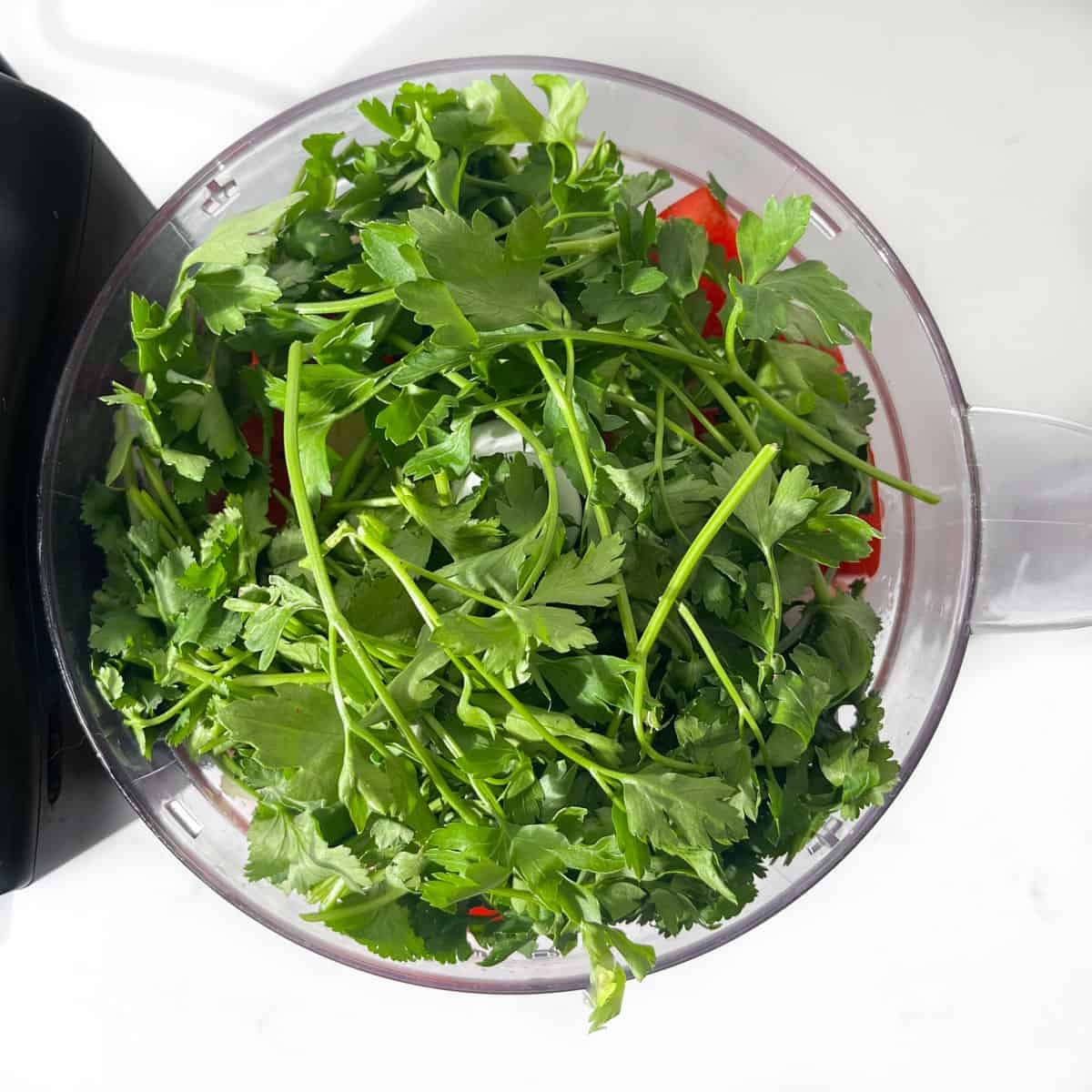 Adding all the ingredients for the Seco de Pollo stew to a blender.