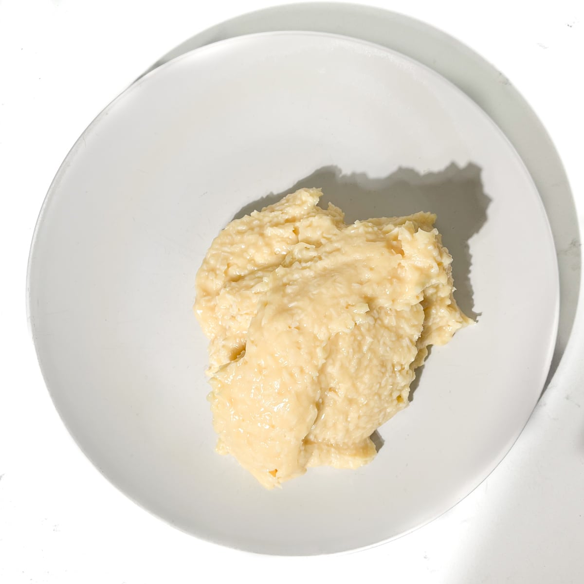 The beijinhos mixture on a buttered plate.