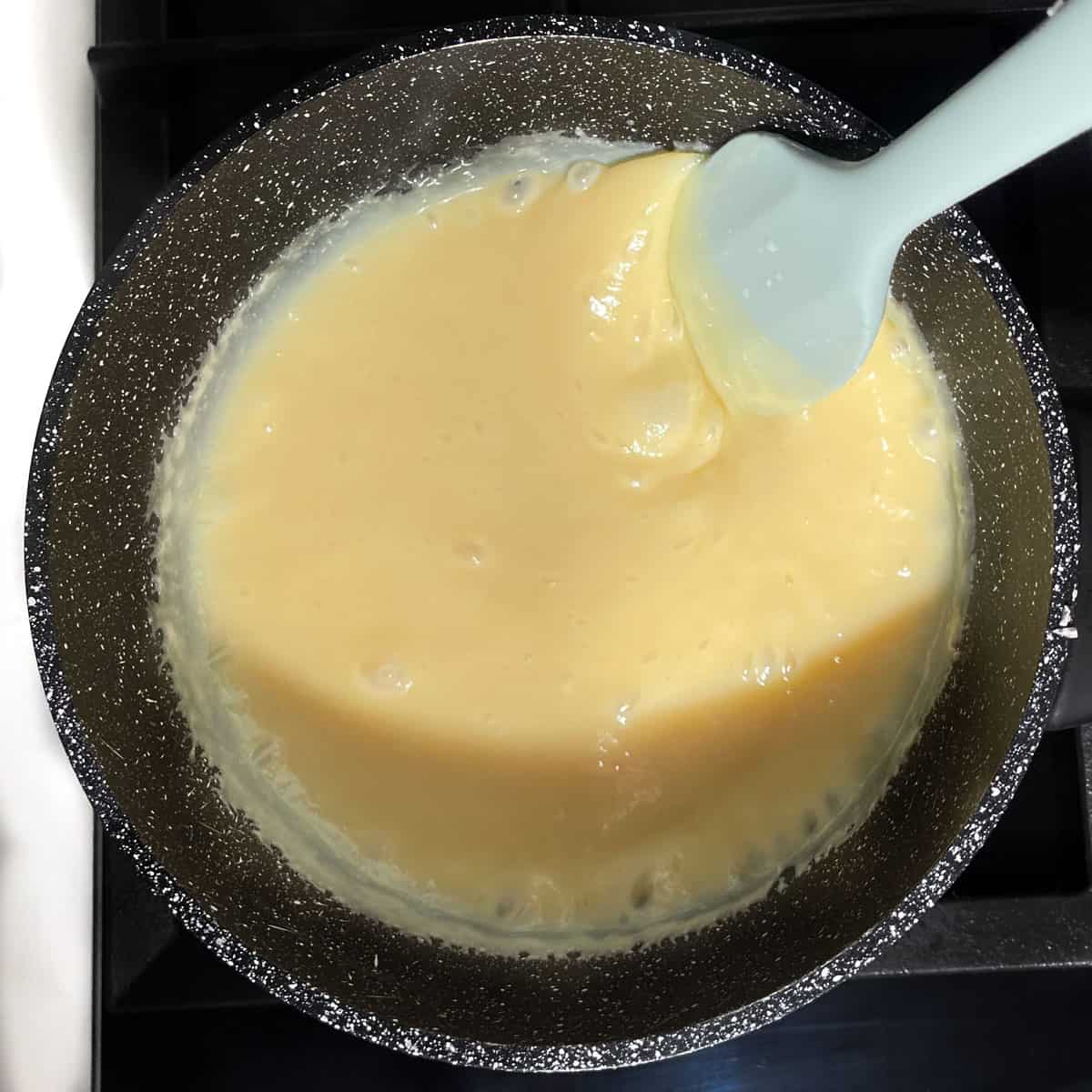 Melting the butter and condensed milk together in a medium saucepan.
