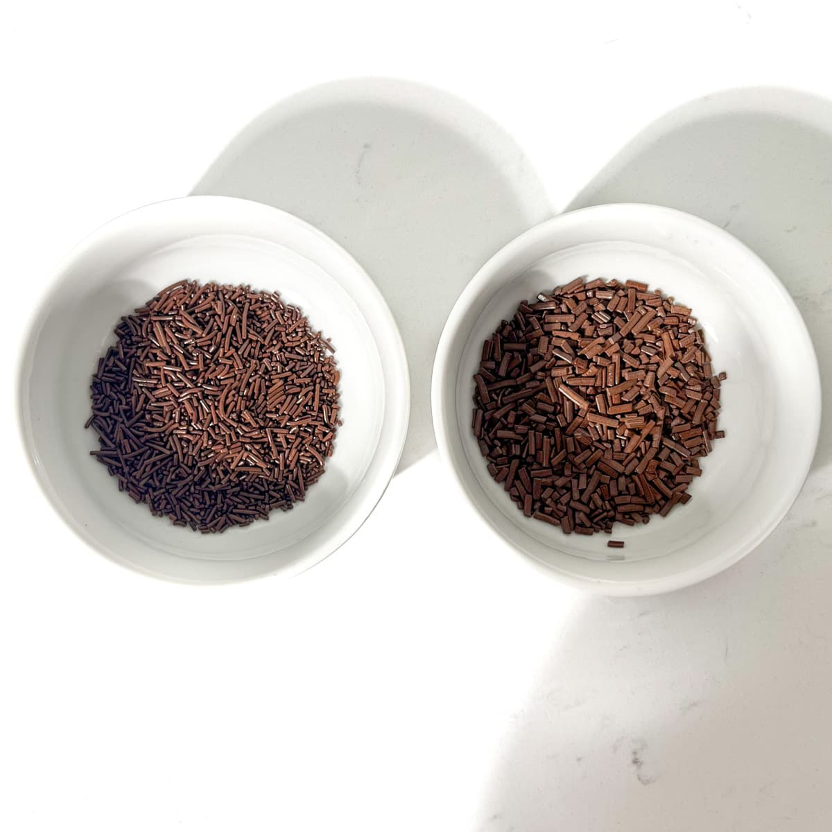 Sprinkles in two small white bowls.