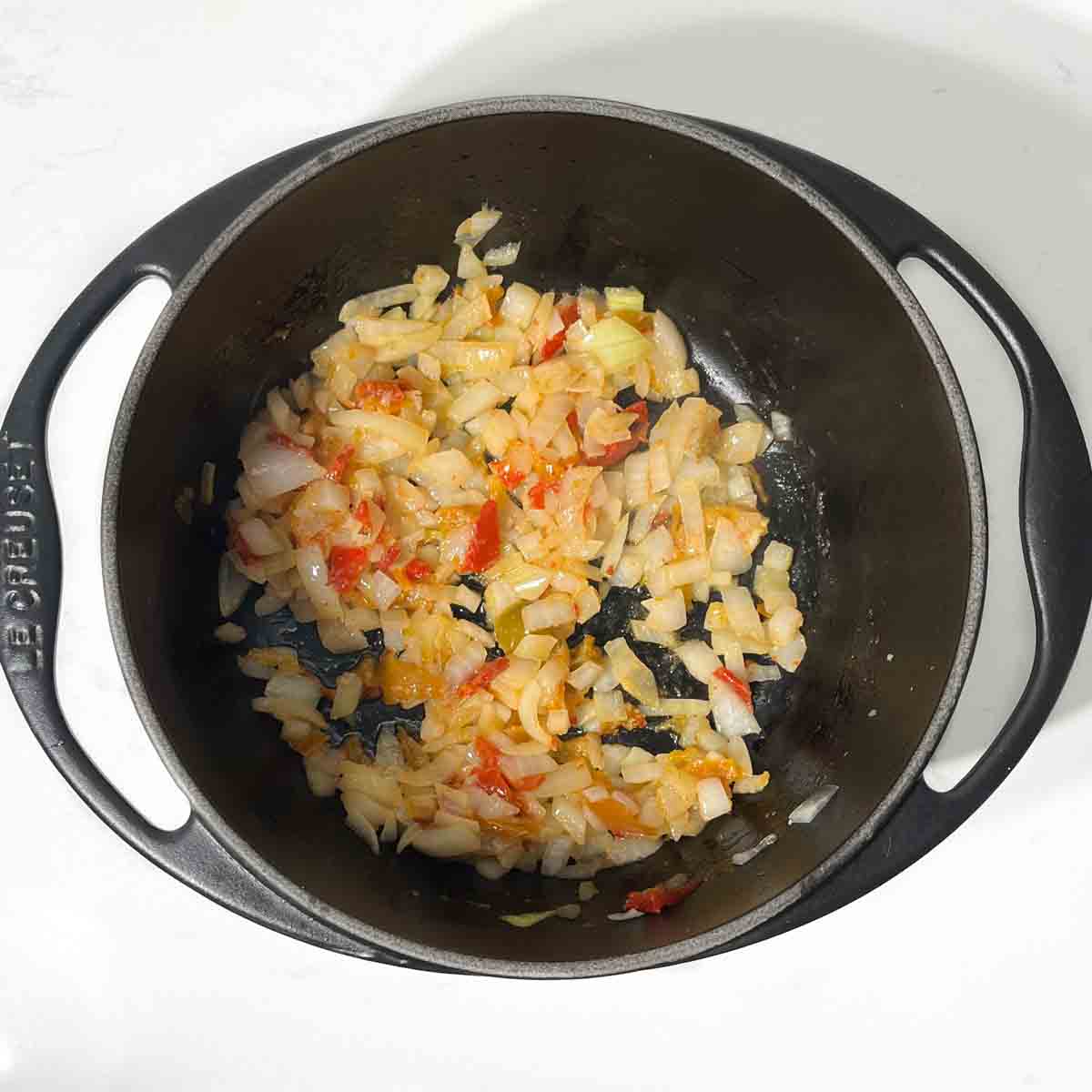 Fried onions, peppers and garlic in a heavy-based saucepan. 