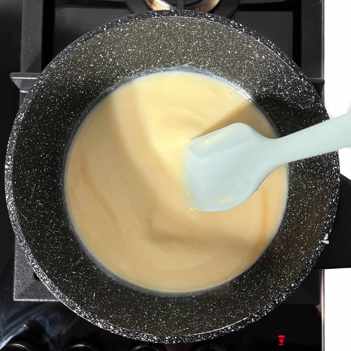 Stirring together the condensed milk, butter, vanilla and salt in a medium saucepan.