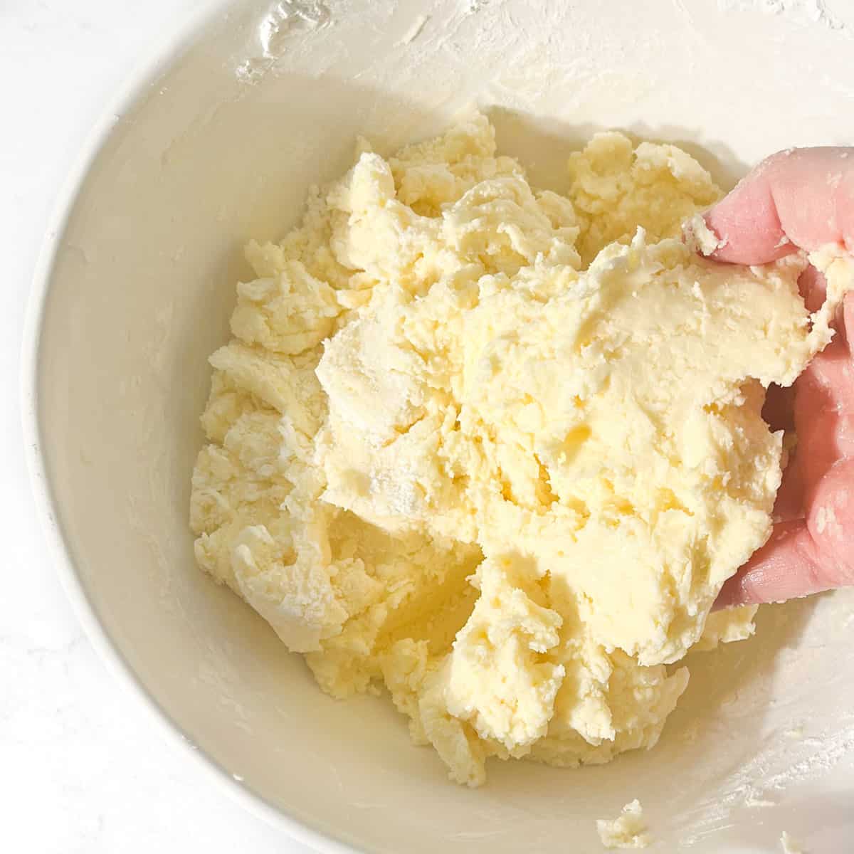 Mixing the cornflour into the dough mixture by hand.