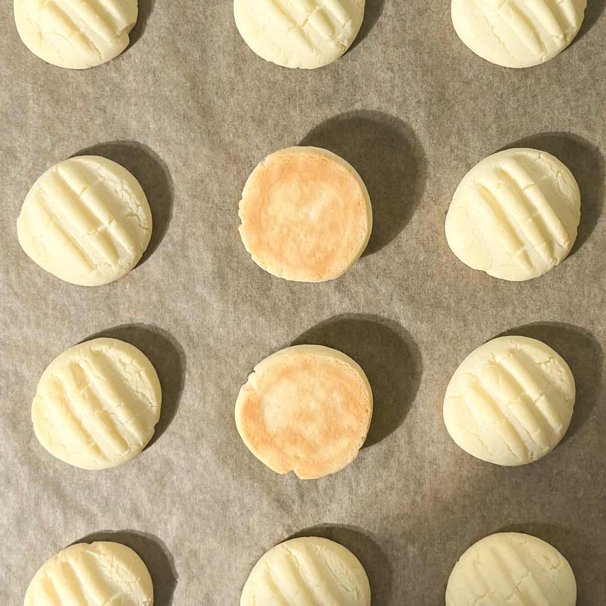 The golden brown undersides of two sequuilho cookies.