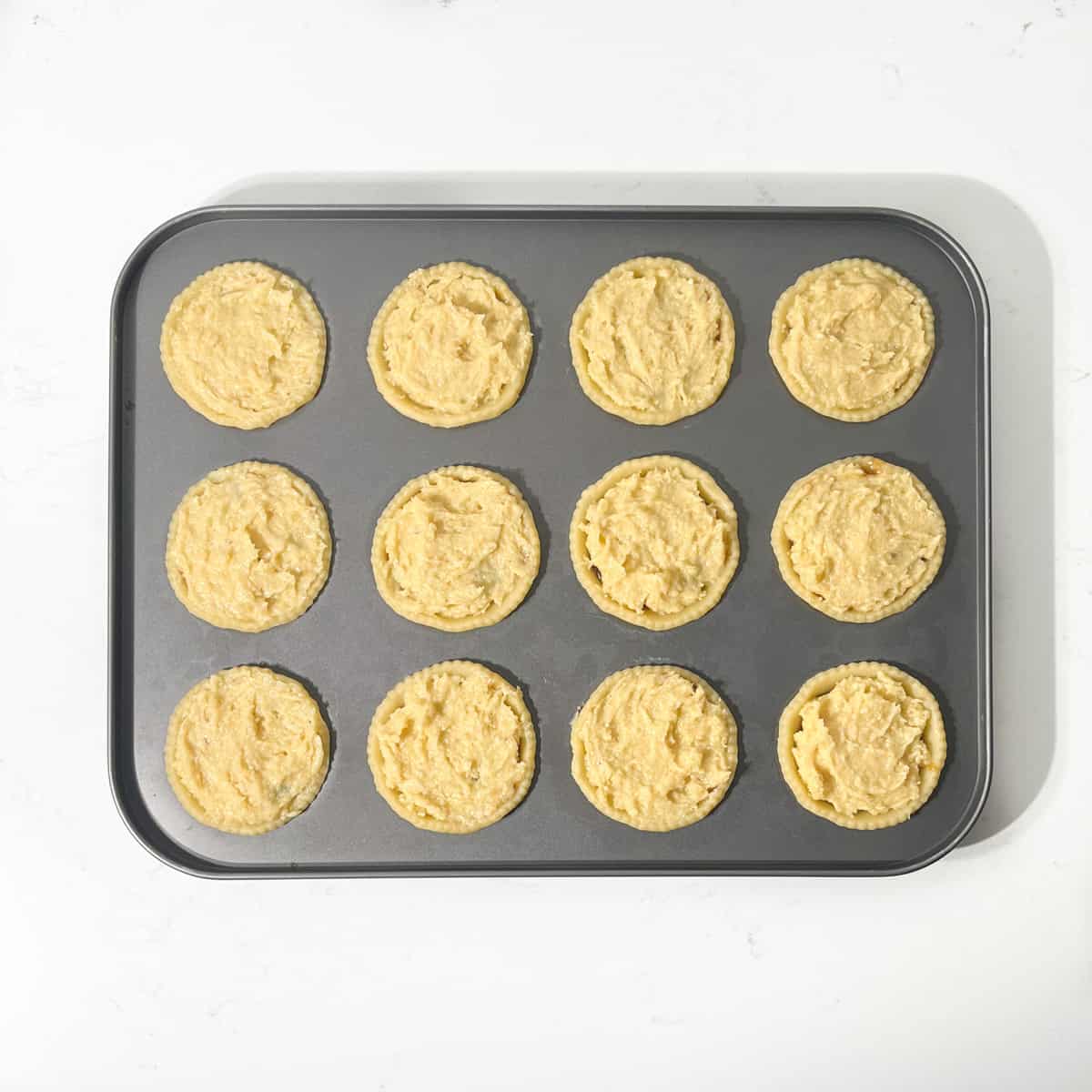 Frangipane mince pies in a fairy tin with frangipane topping added.