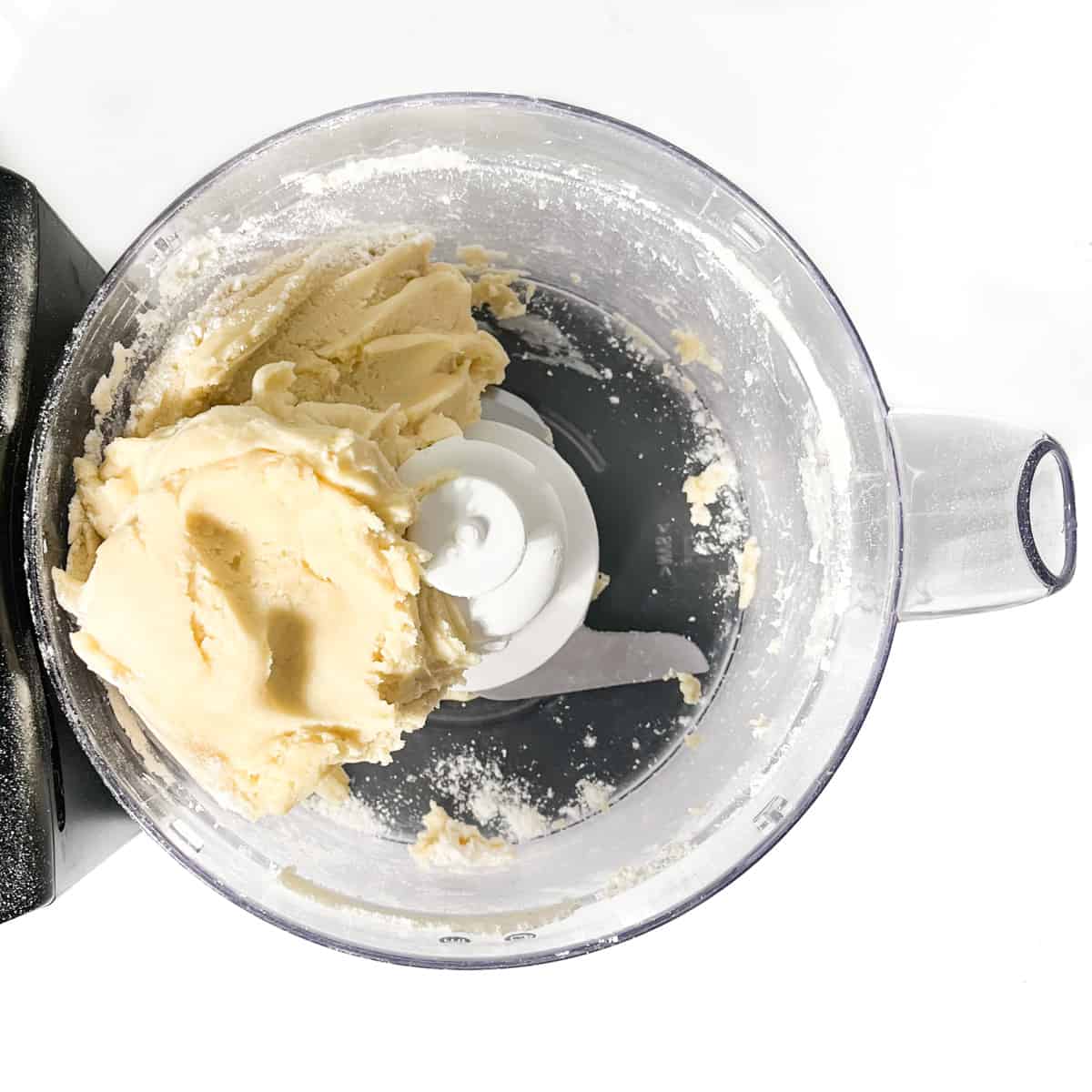 A ball of pastry dough in a food processor.