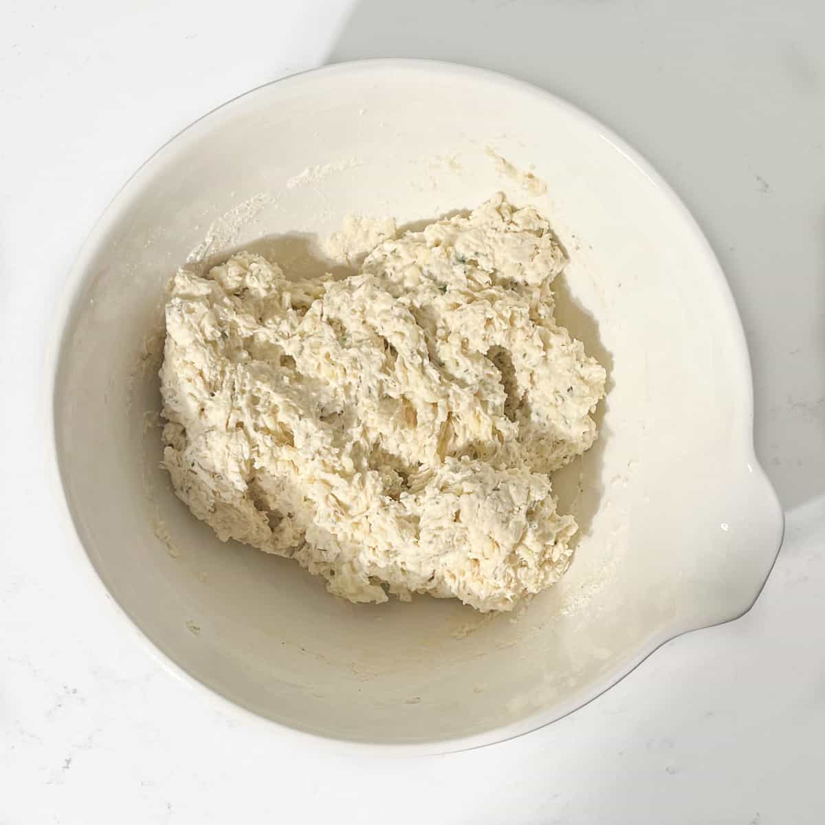 Dumpling mixture in a large white bowl for the Mince and Dumplings.