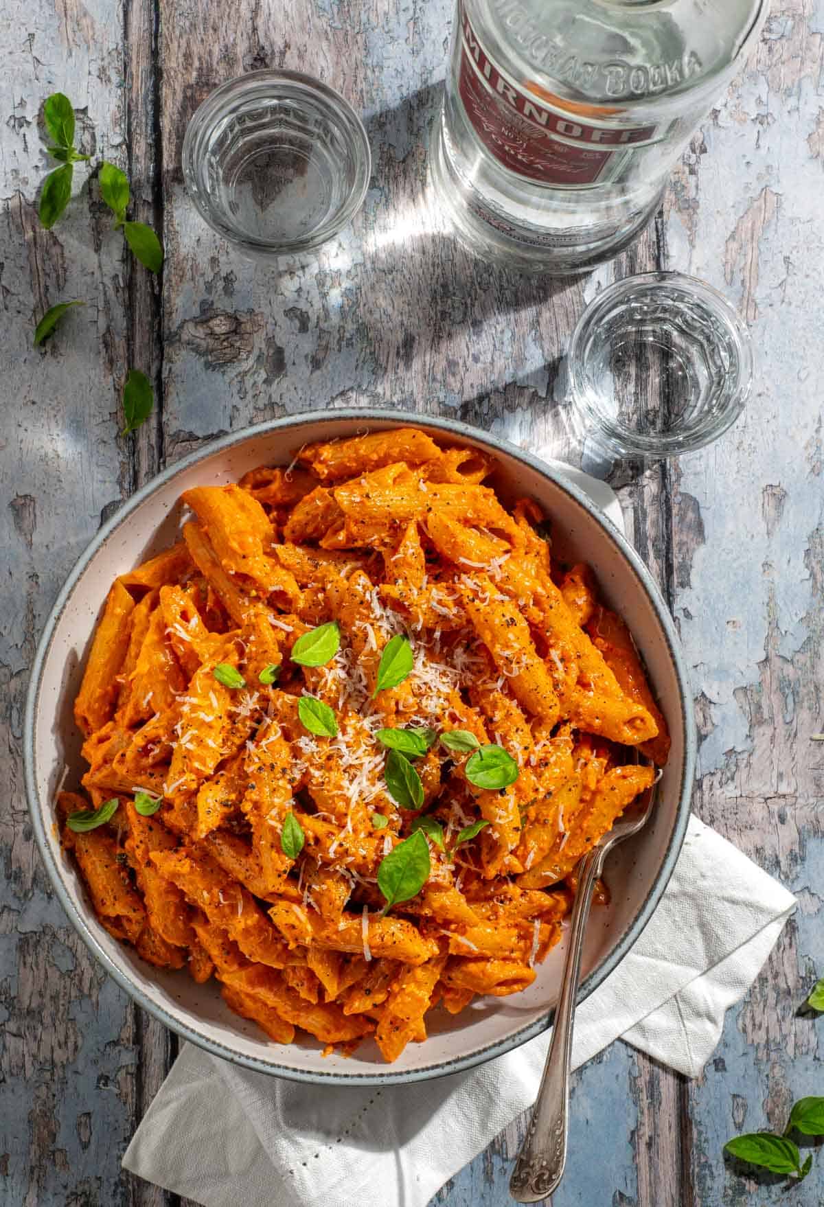 Gigi Hadid pasta in a bowl next to a bottle of vodka.