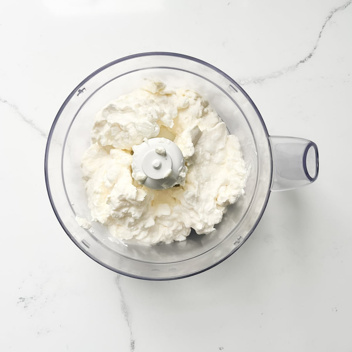 Crumbly cottage cheese in a food processor. 