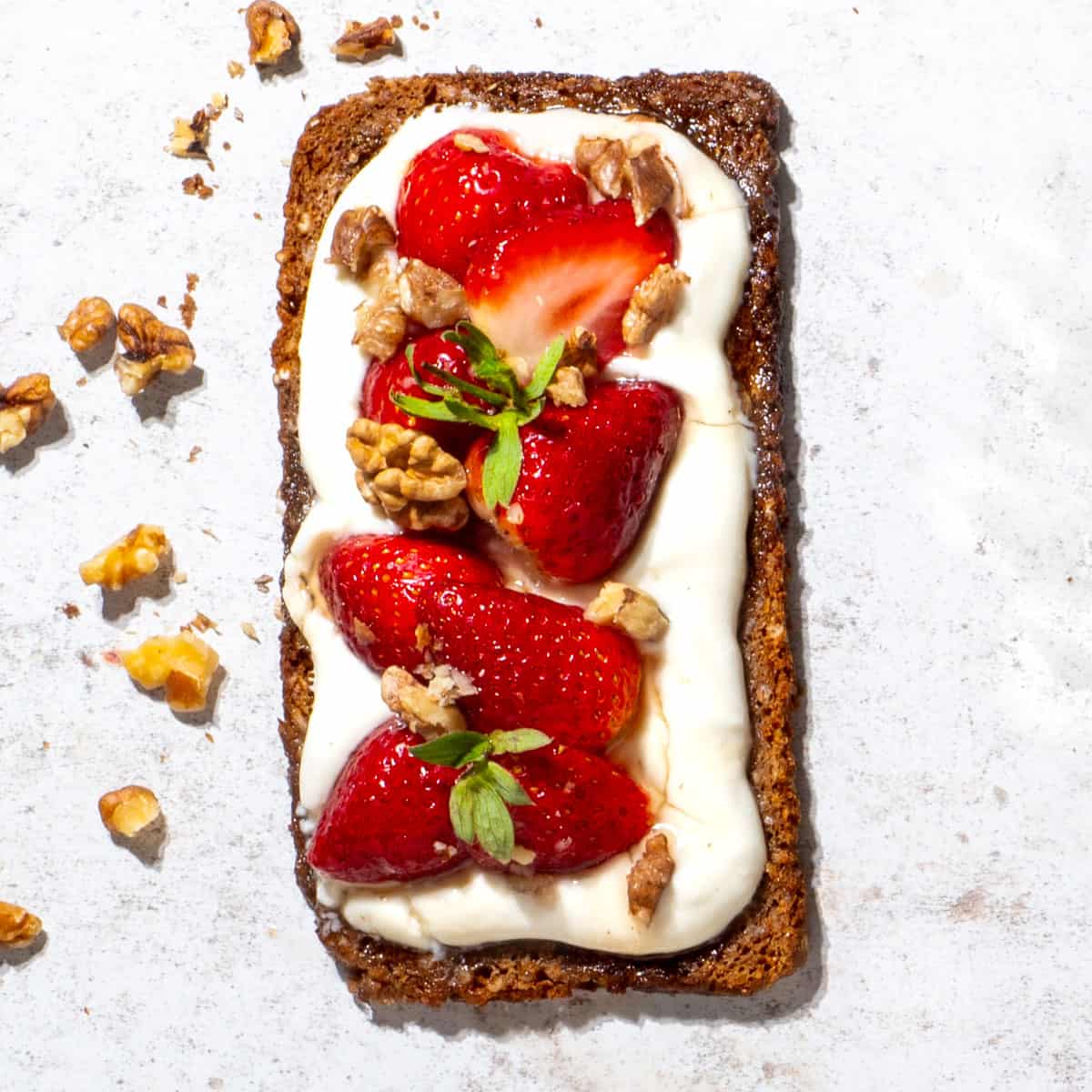 Cottage cheese toast with strawberry and honey topping.