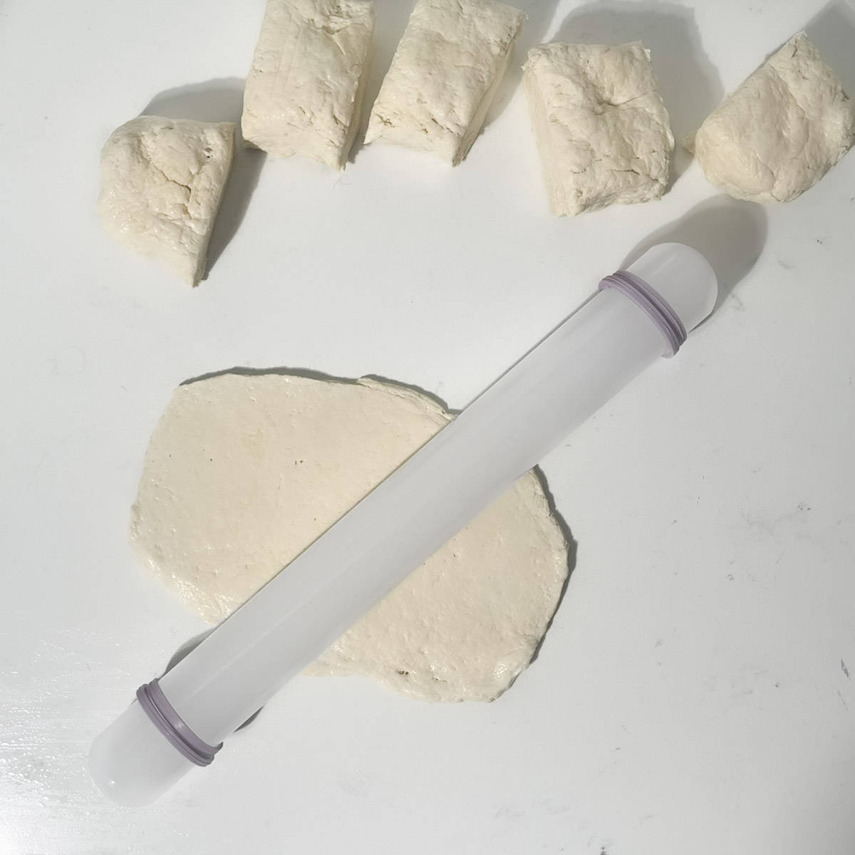 Rolling out a 2 ingredient flatbread with a rolling pin.