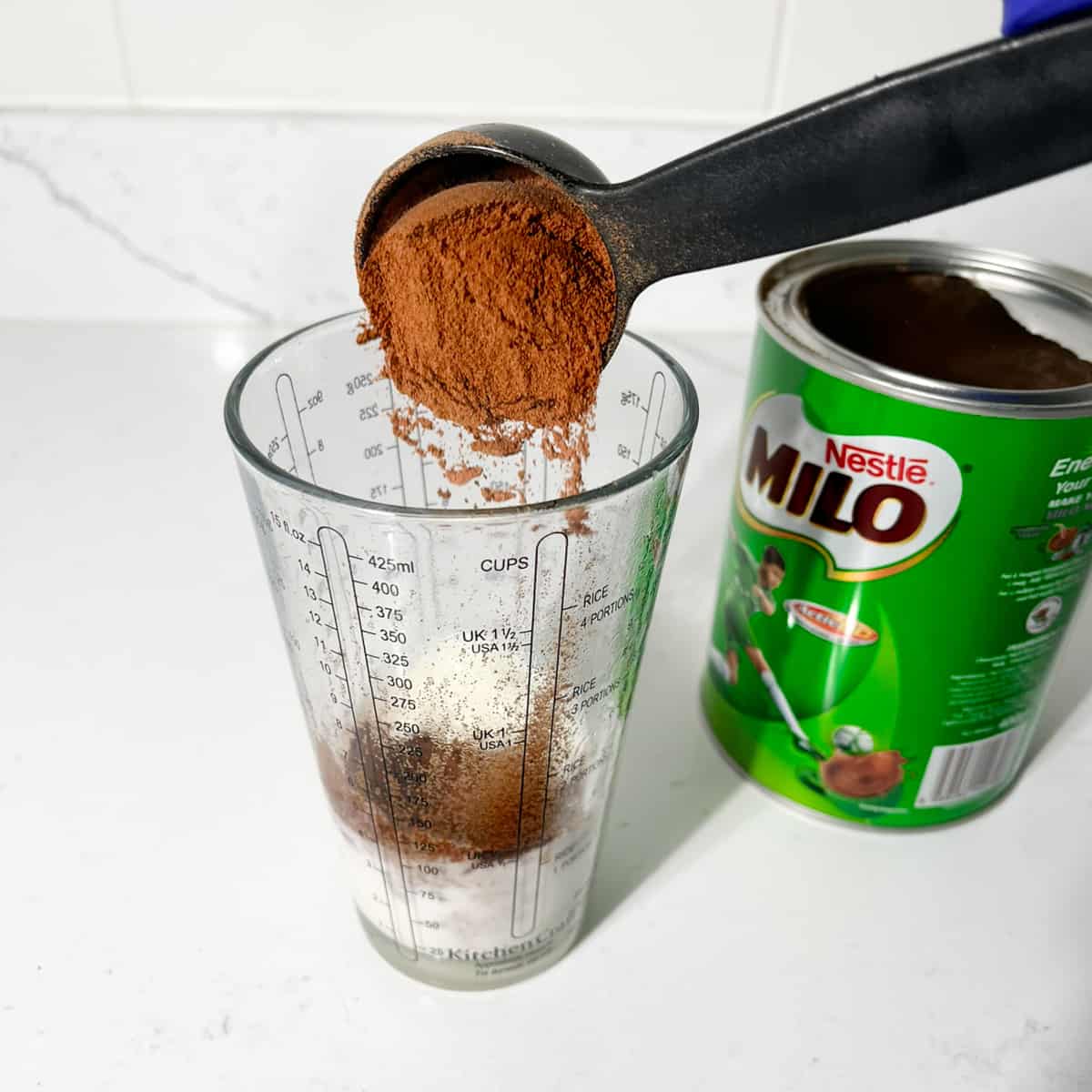 Adding milo to boiled milk.